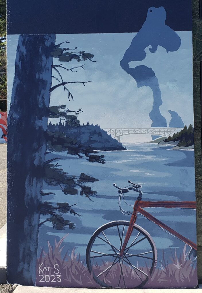 Photo of mural featuring a bike next to a tree and the ocean